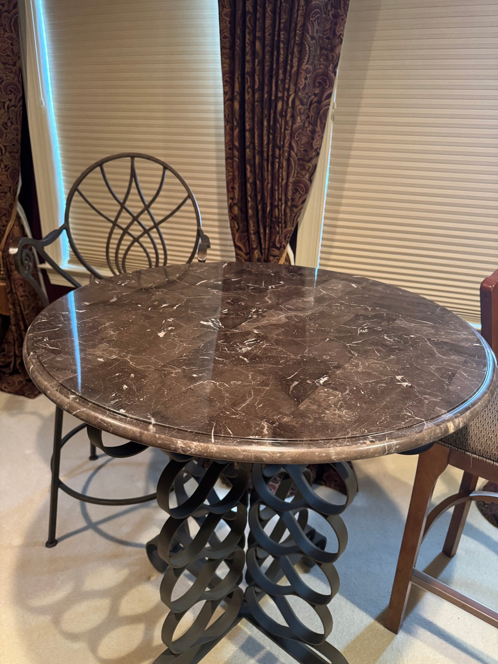 Close-up of dark marble tabletop showing natural veining and patterns, circular surface detail