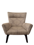 Front view of cream and black dot patterned lounge chair with high back, rolled arms, and dark wooden splayed legs