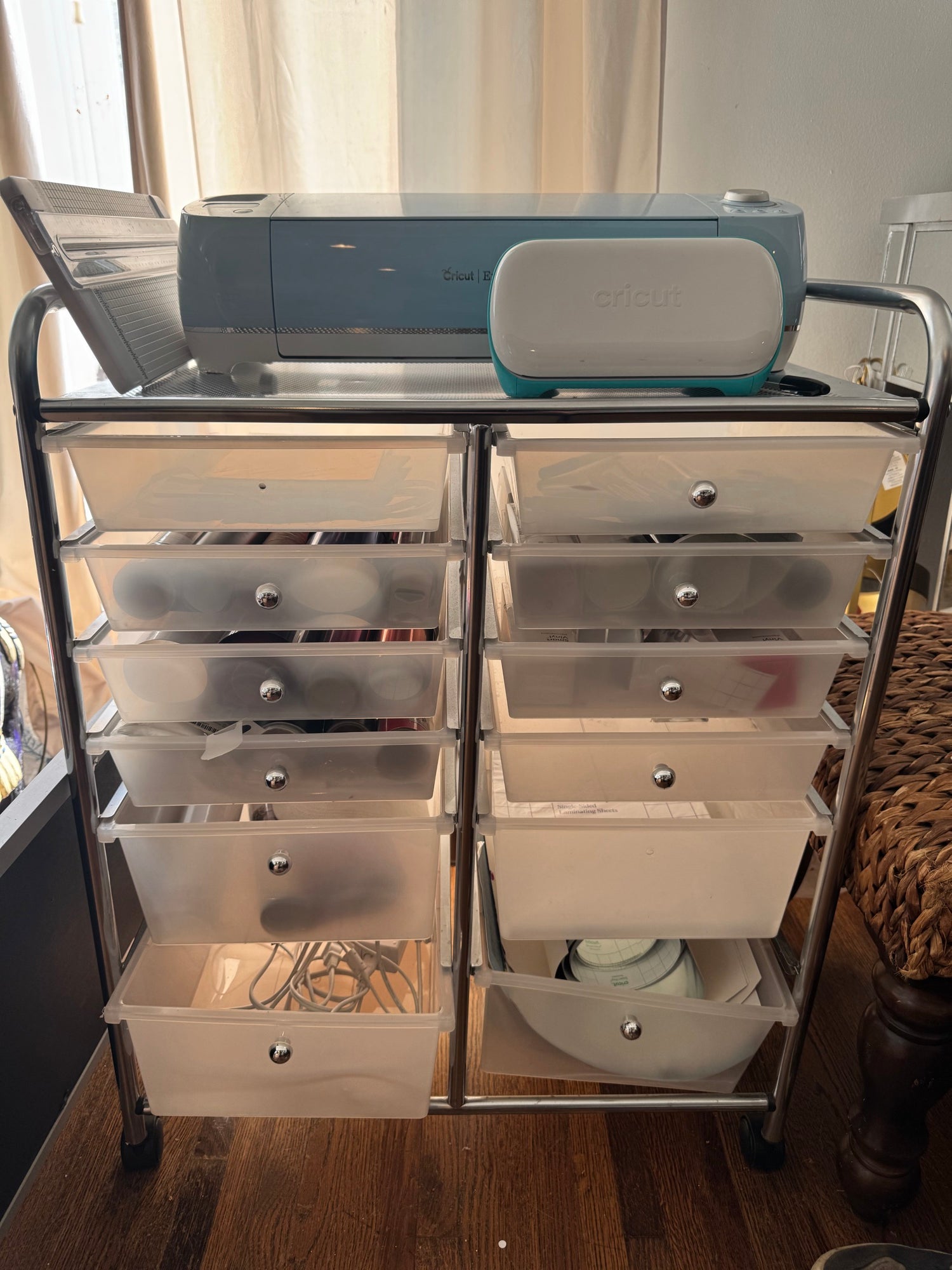 Rolling supply cart with dual column drawers containing Cricut materials and supplies