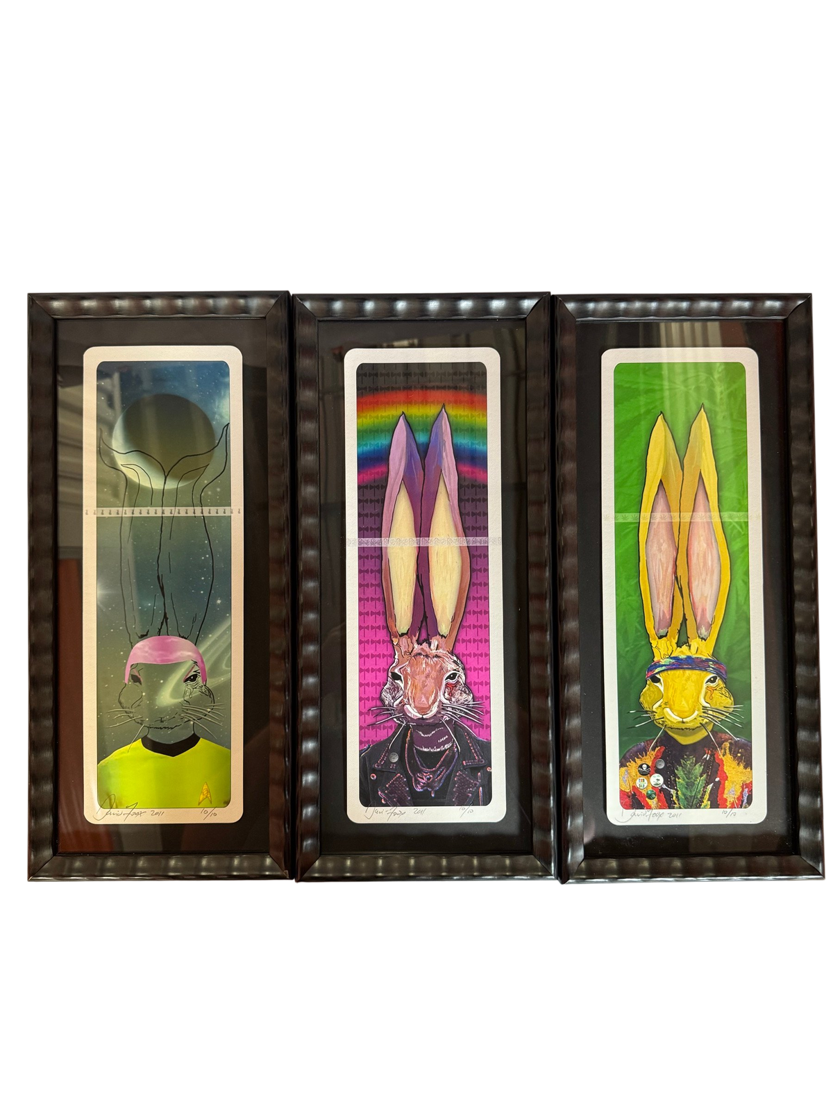 Set of three framed rabbit portrait prints in blue, pink and yellow, straight-on