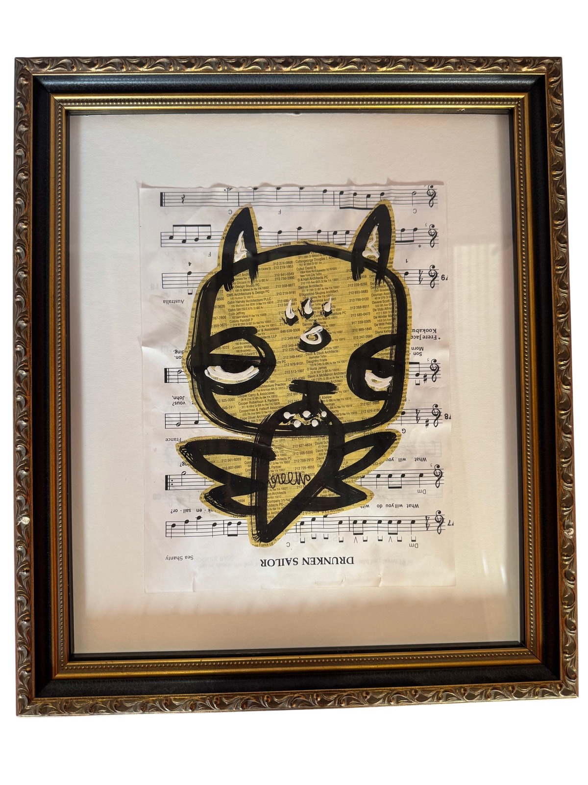 Framed black-ink cat creature on Drunken Sailor sheet music, straight-on