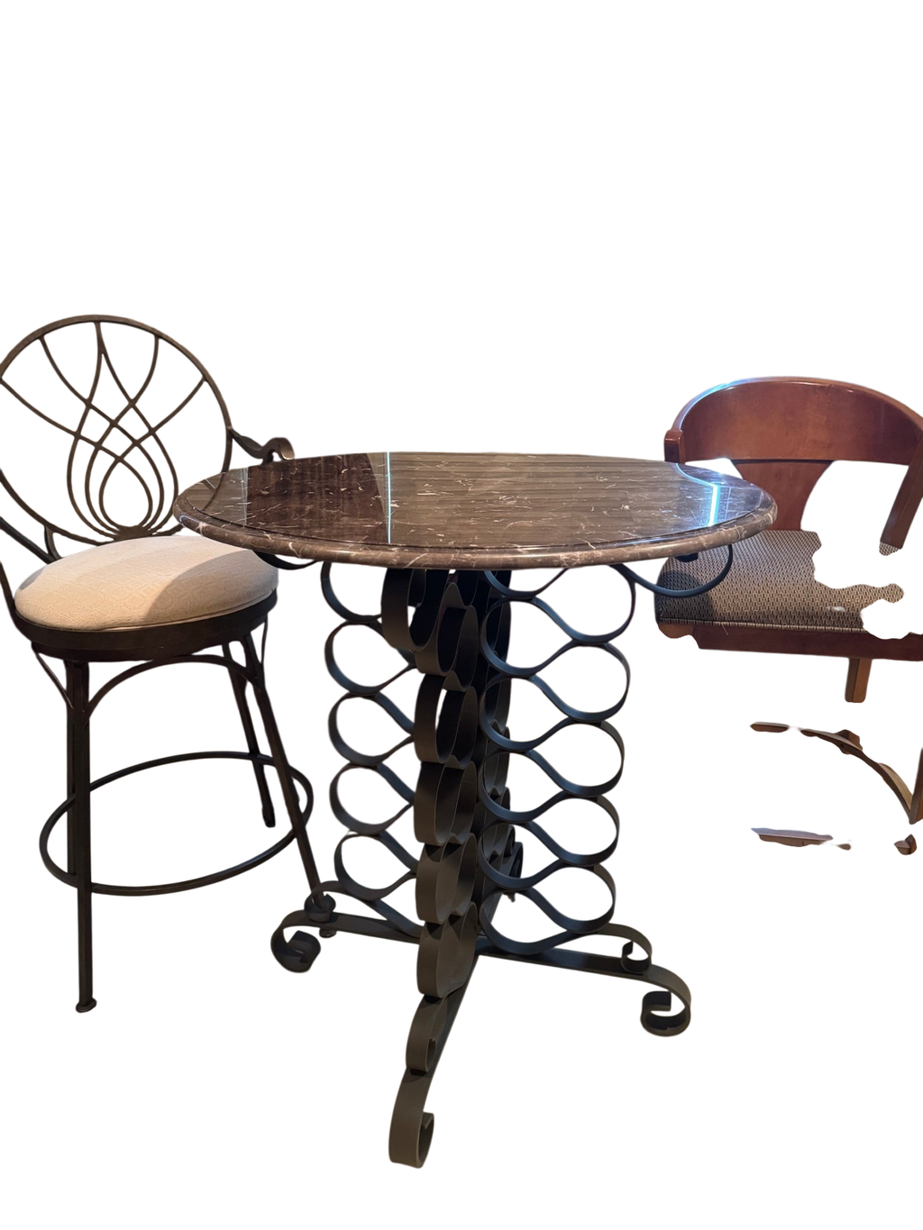 Round marble-top pub table with ornate scrolled iron pedestal base, viewed from above with two matching stools