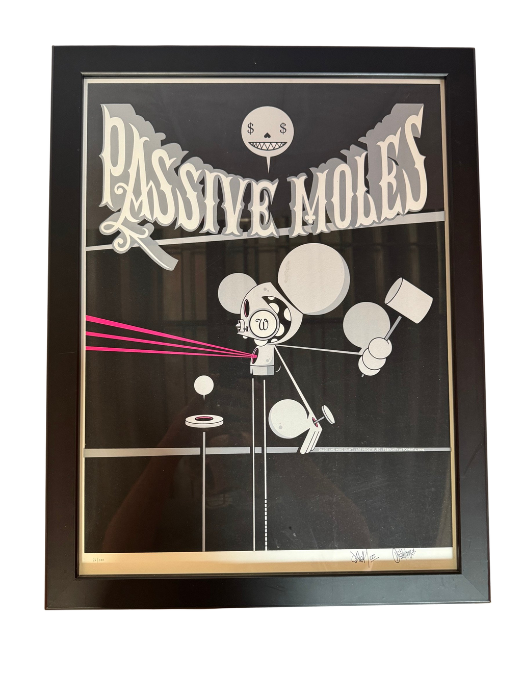 Passive Moles poster print in black frame, straight-on