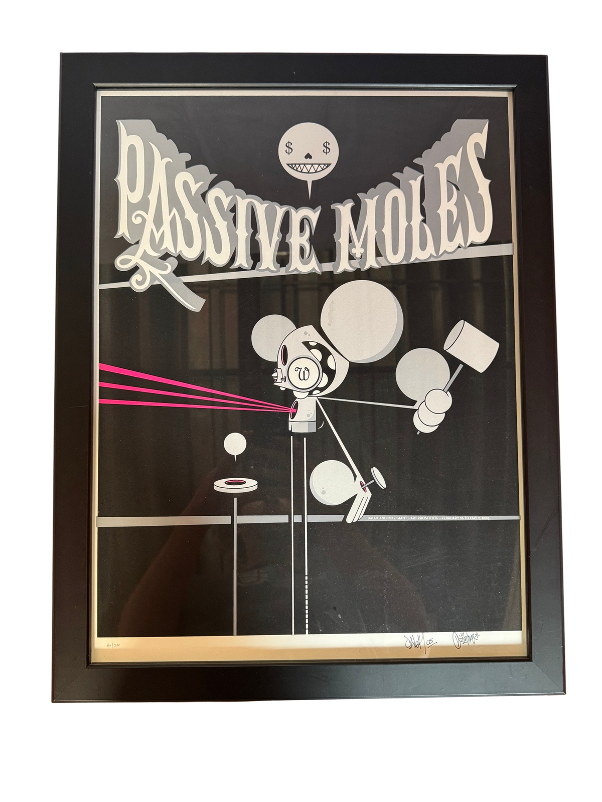 Passive Moles poster print in black frame, straight-on