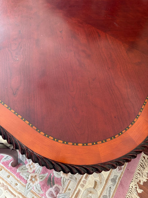 Close view of the table top showing the inlaid band and rope-carved edge
