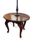 Round cherry finish side table with scalloped edge and cabriole legs, shown with a lamp not included in this listing