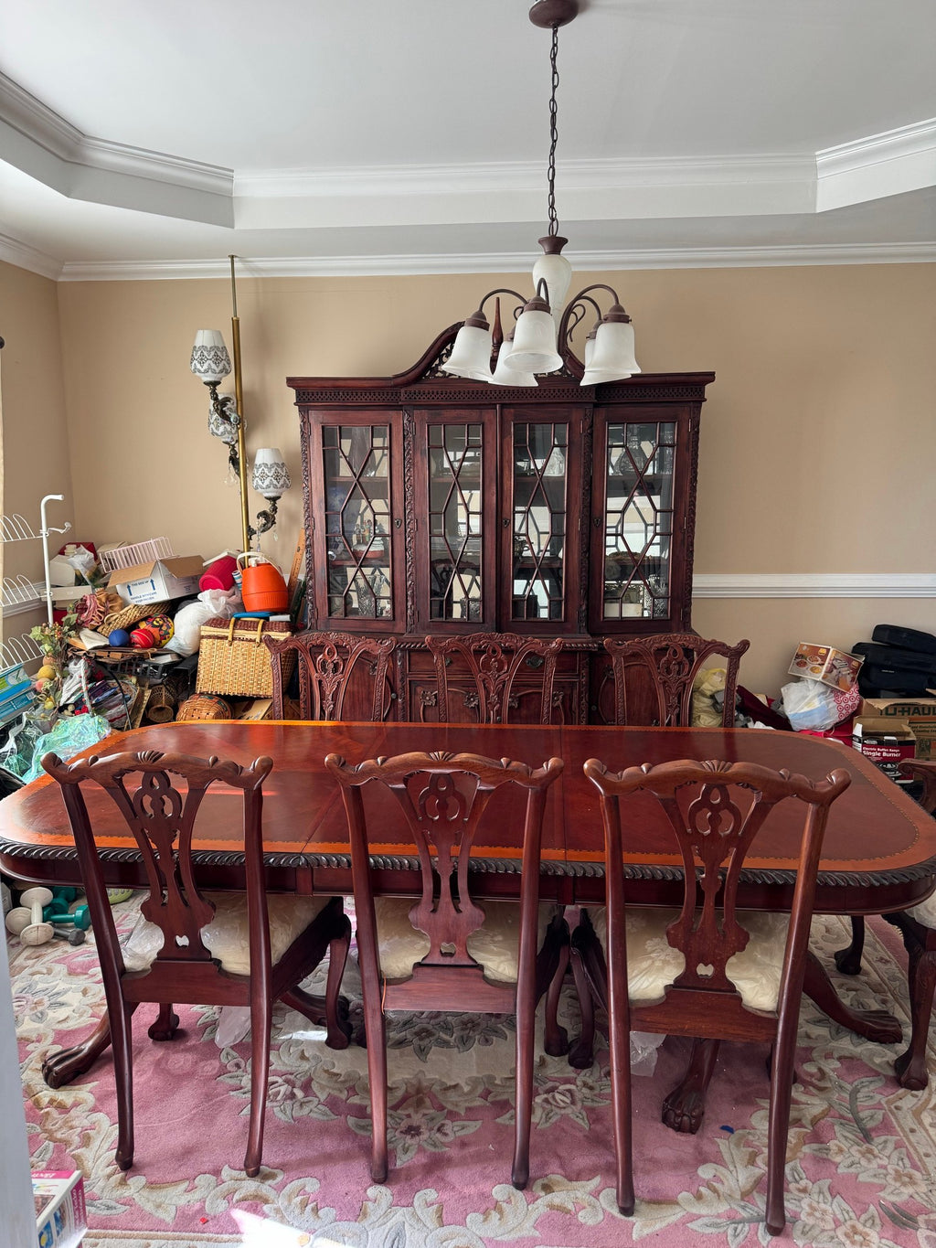 Dining room with oval table, carved chairs and breakfront china cabinet