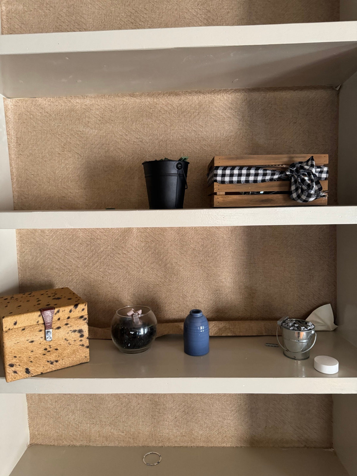 Boxes, vase and small decor on lower shelves