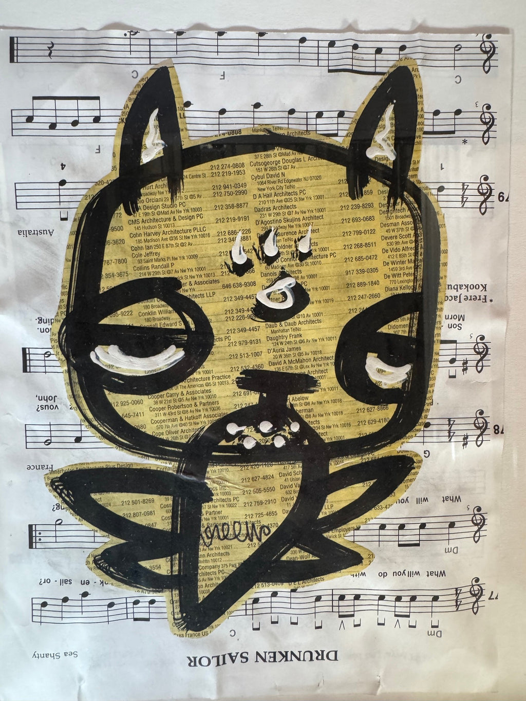 Detail of the cat face and newsprint