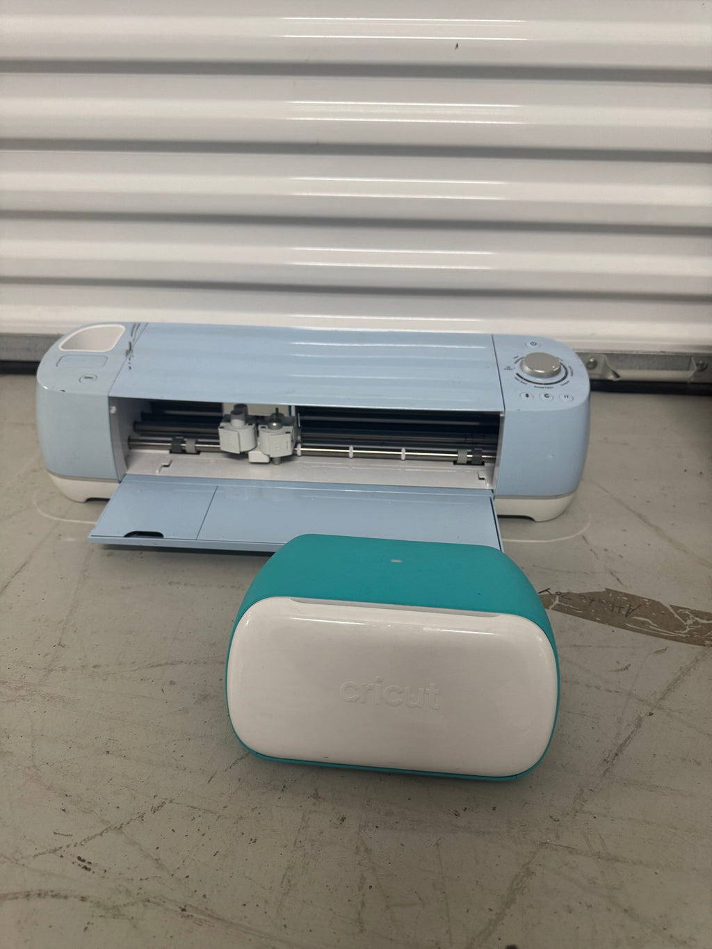 Cricut Explore Air 2 cutting machine with teal and white Cricut Joy machine positioned in front