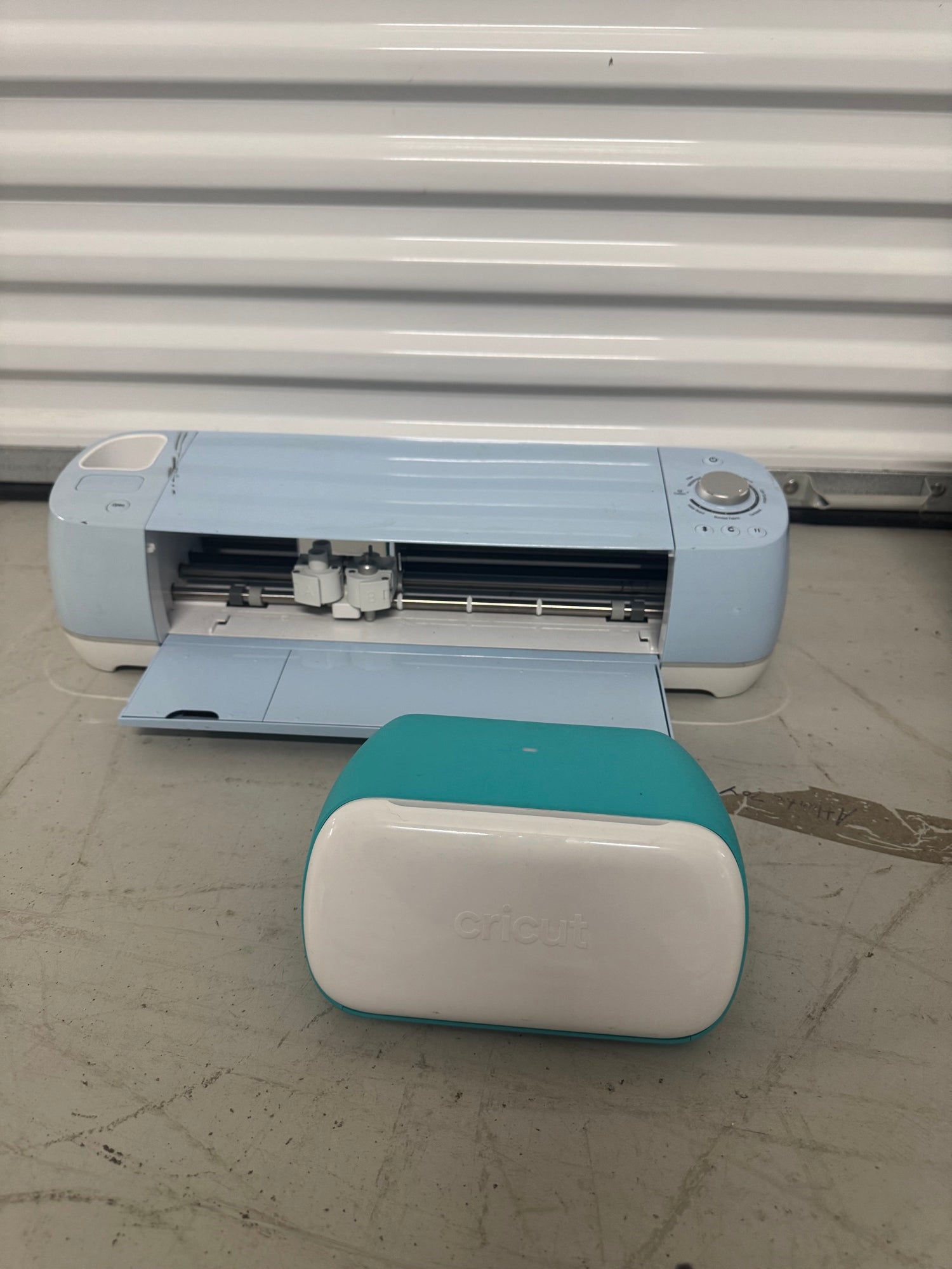 Cricut Explore Air 2 cutting machine with teal and white Cricut Joy machine positioned in front