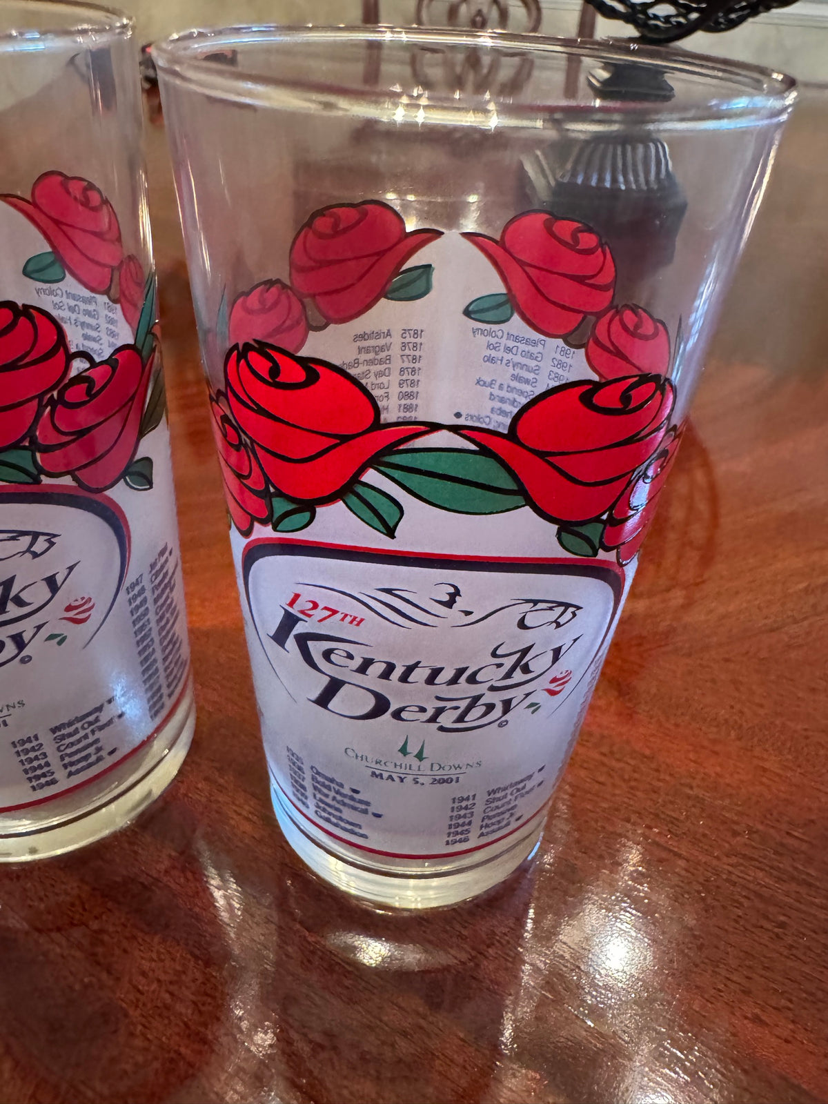 Close-up of two Kentucky Derby 127th 2001 glasses showing rose border and Churchill Downs label
