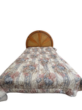 Bed with arched oak and cane sunburst headboard in a bedroom