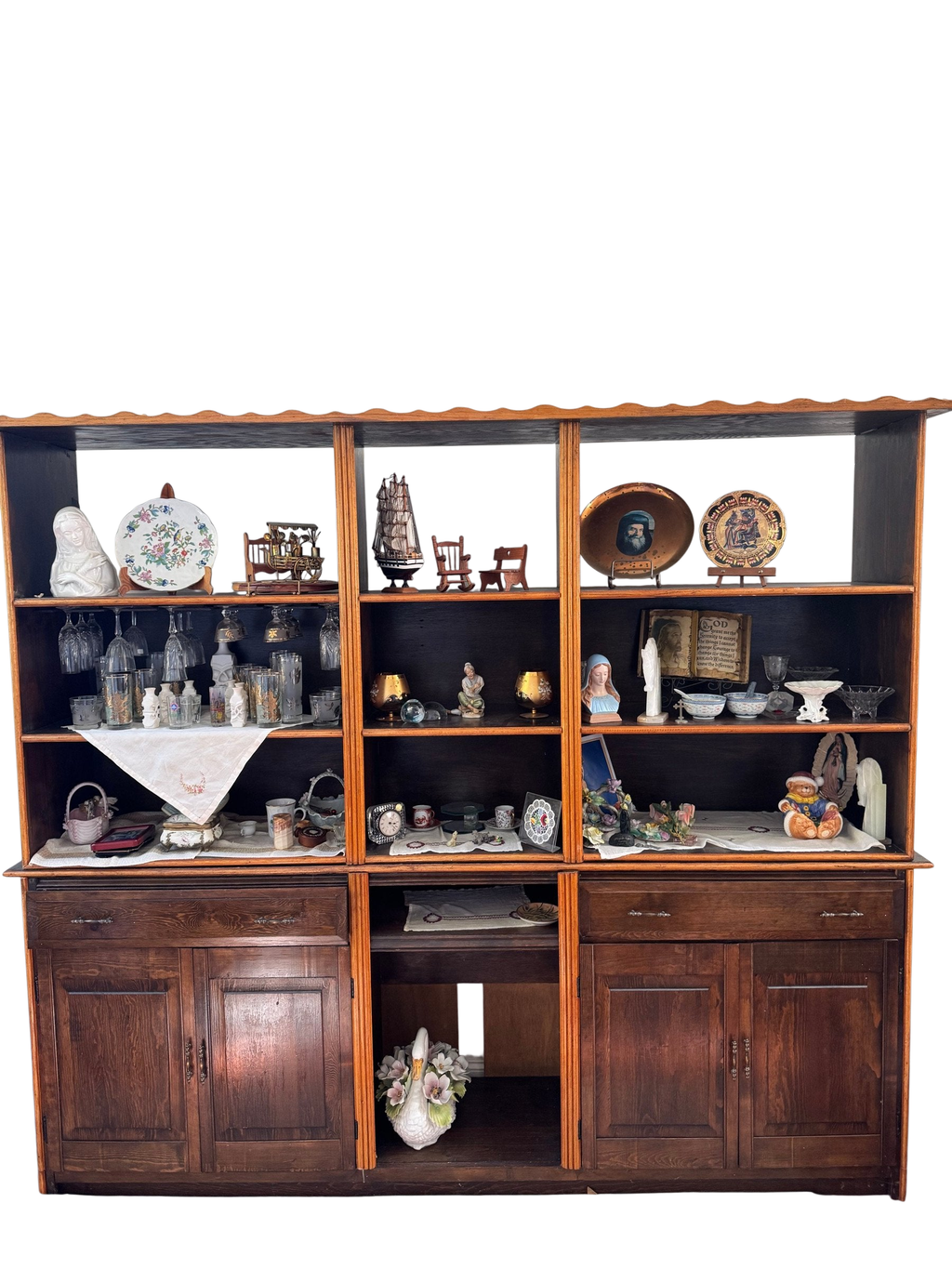 Dark wood wall unit with open shelves above and cabinets below, filled with decor