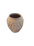 Large patterned urn planter on a porch