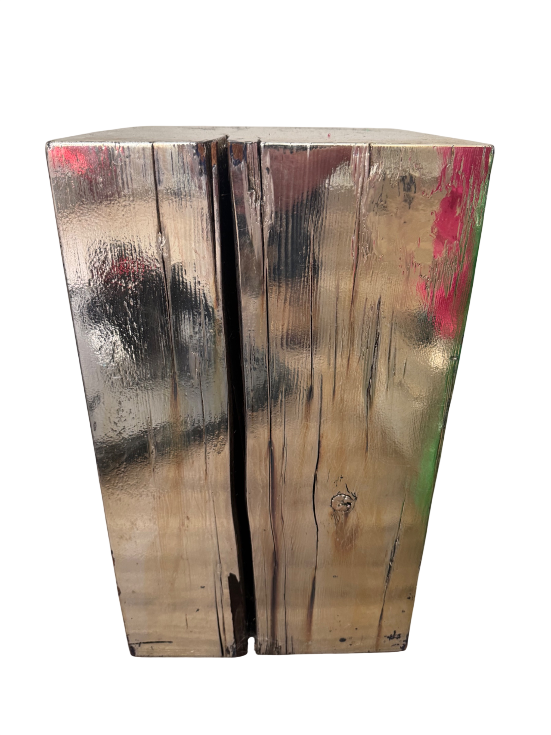 Wooden log pedestal table viewed from front, painted with silver leaf and pink paint splatter, trapezoid shape with visible grain and knots