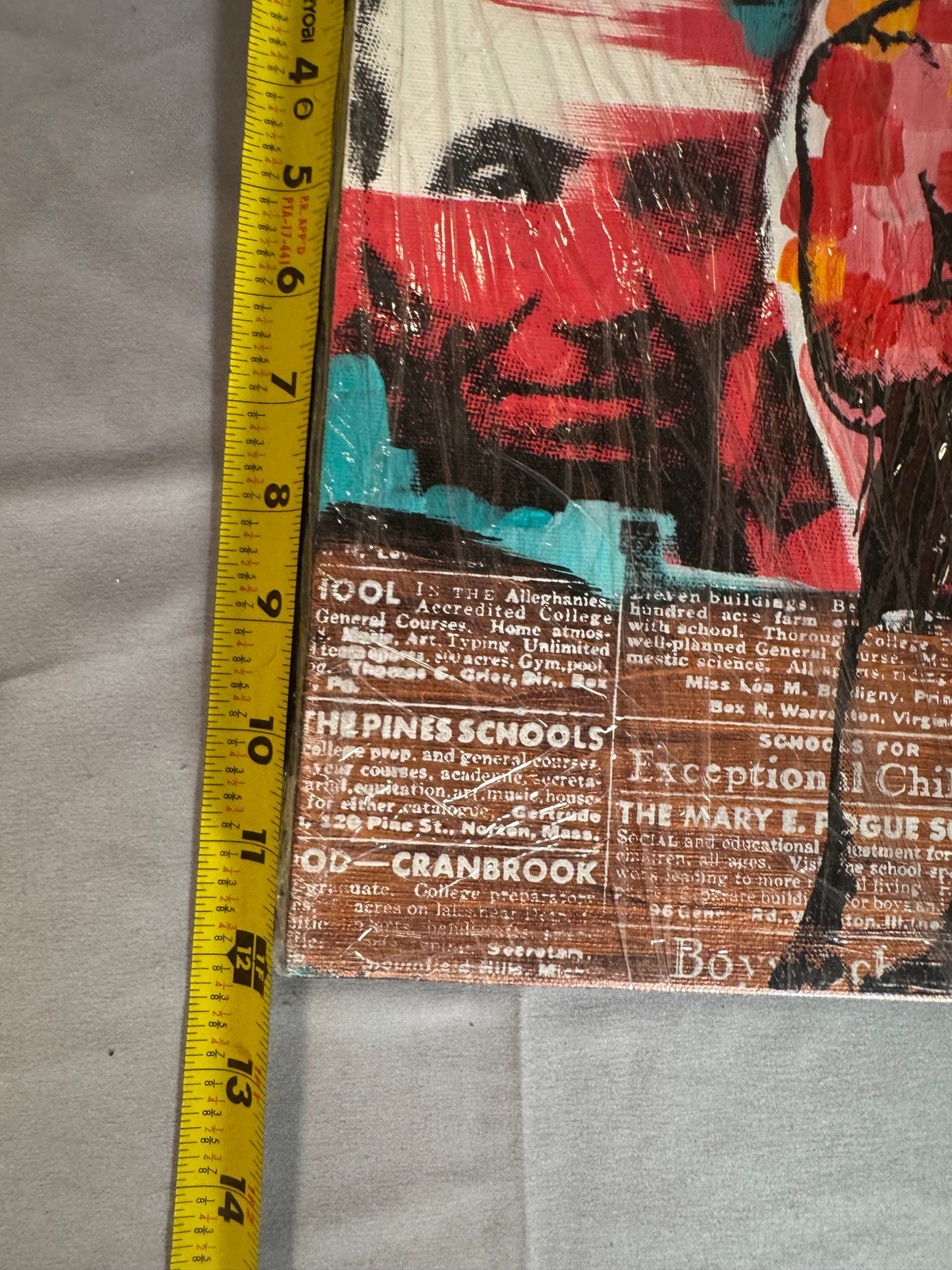 Tape measure held against the canvas showing its size
