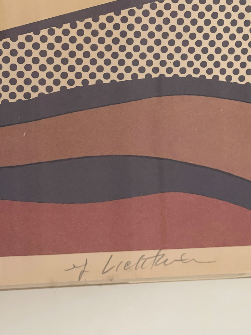 Close-up of lower portion displaying artist signature and wavy landscape bands in rust, navy, and tan colors