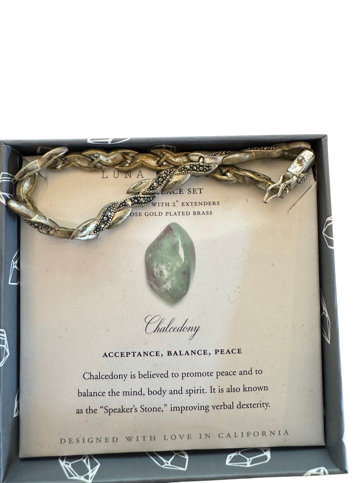 Luna Chalcedony bracelet set in box with rose gold plated brass snake-design chain and informational card describing the stone