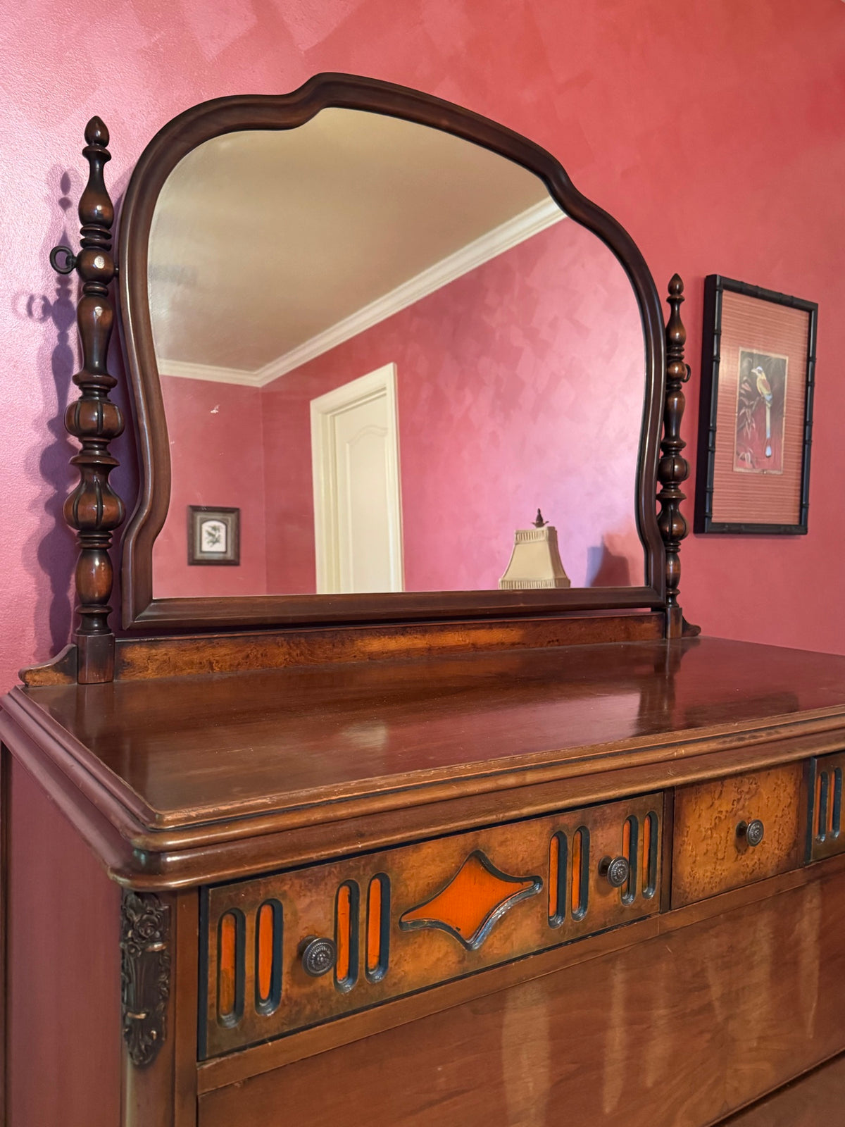 Mirror and upper frame detail, showing carved wooden finials, arched mirror frame, and decorative veneer work on dresser top