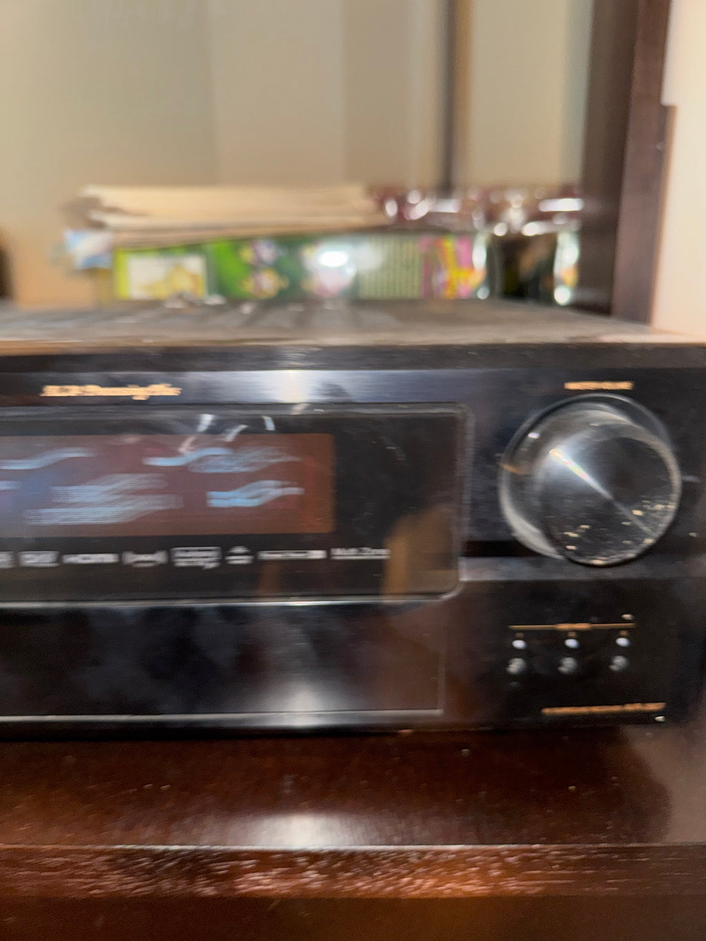 Blurred close-up of Denon AVR-2807 display and volume knob