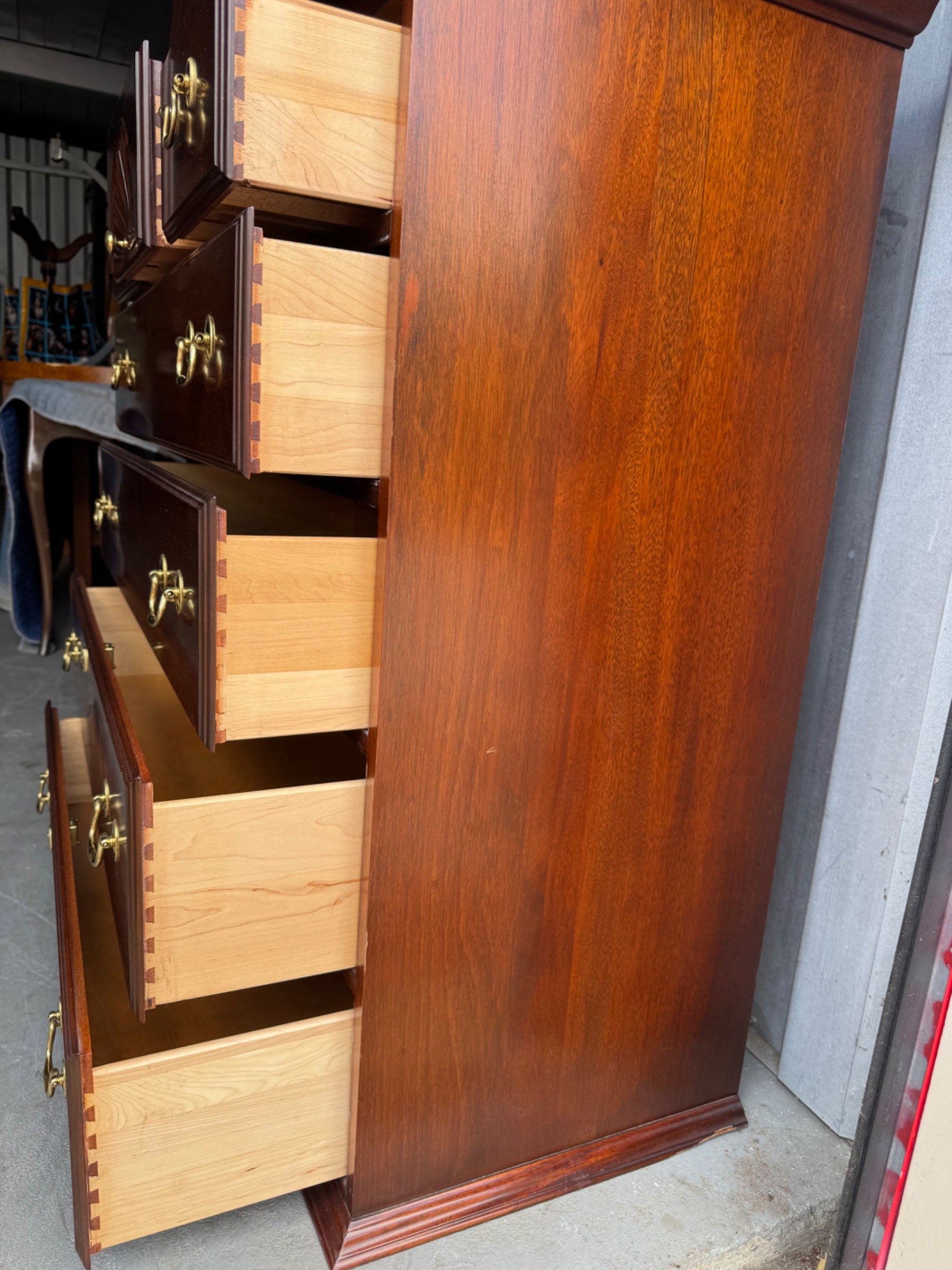 Interior of lowboy drawer showing light wood construction with dovetail joinery and carved shell ornament detail