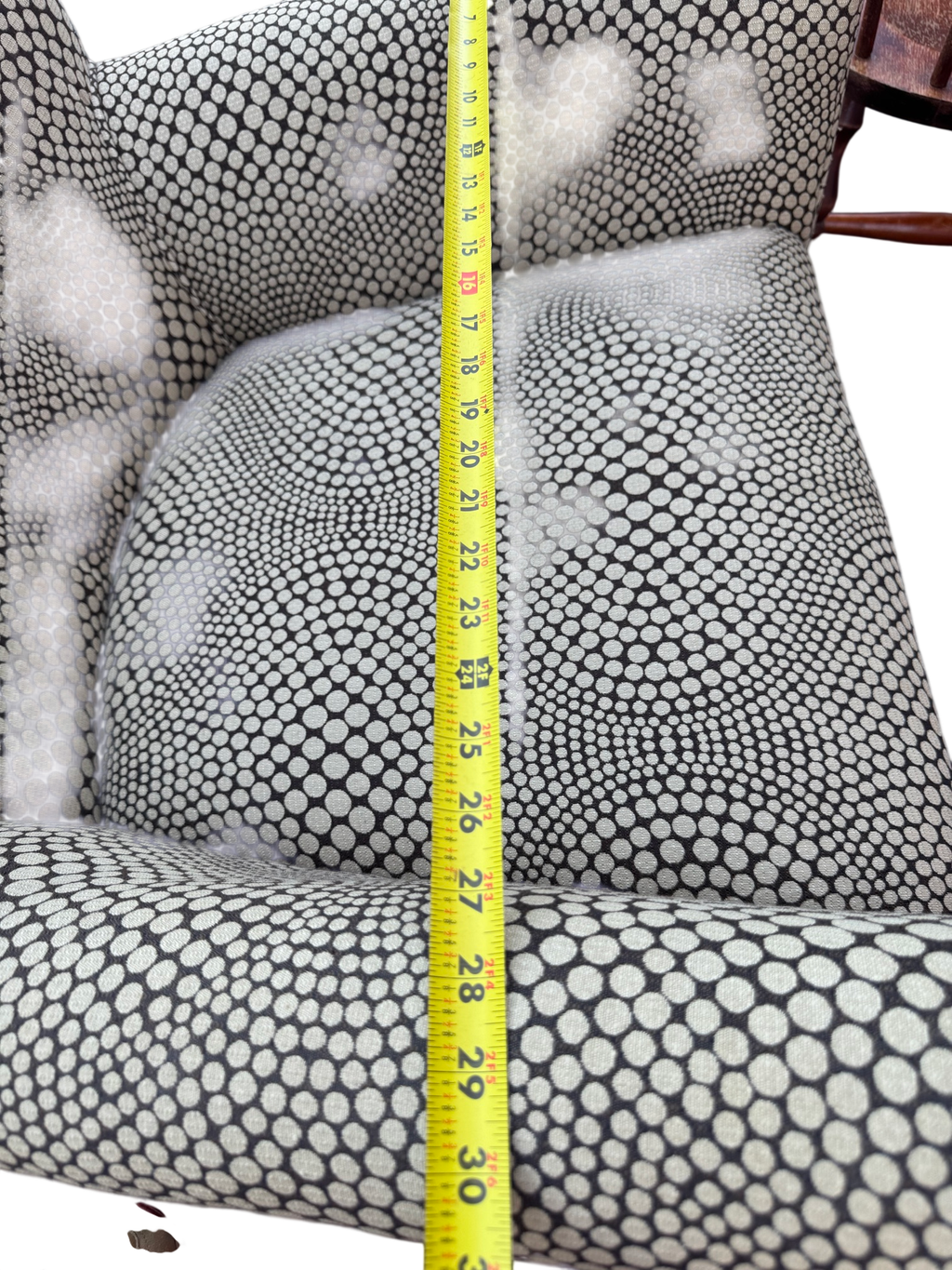Measurement of seat depth using yellow tape measure, showing approximately 27 inches