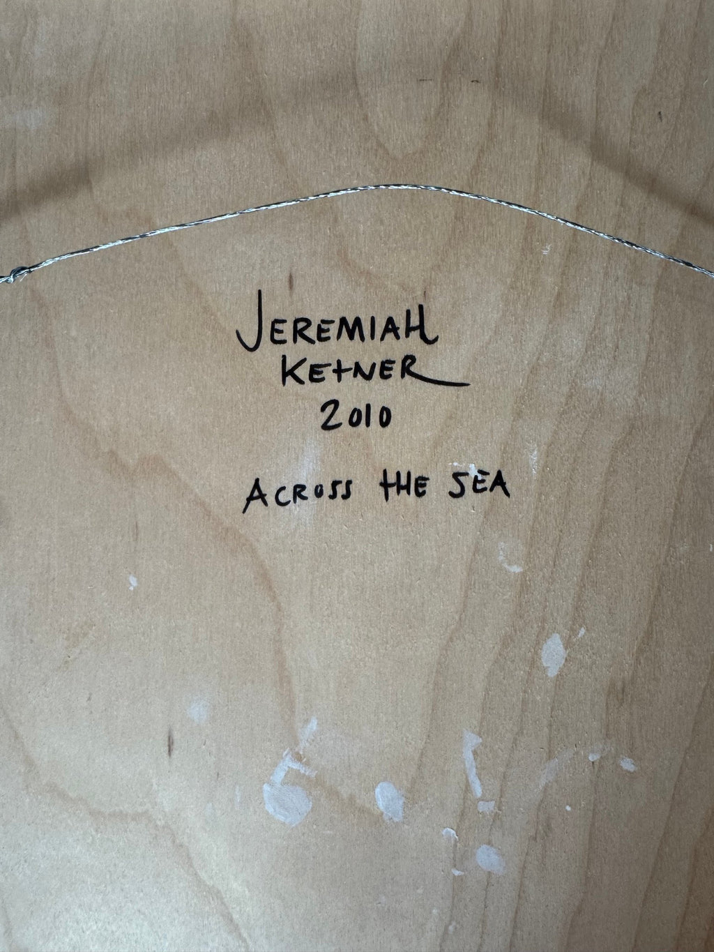 Back of the panel with handwritten signature, year and title