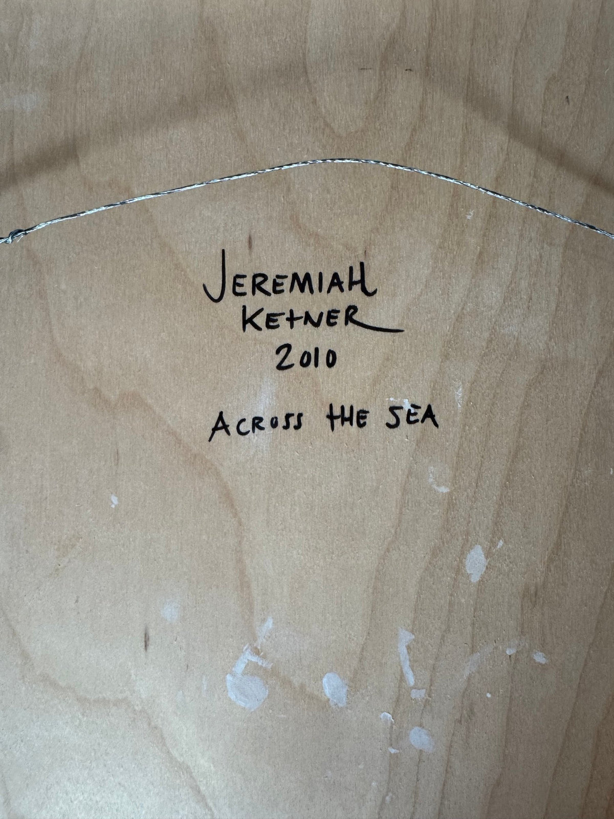 Back of the panel with handwritten signature, year and title