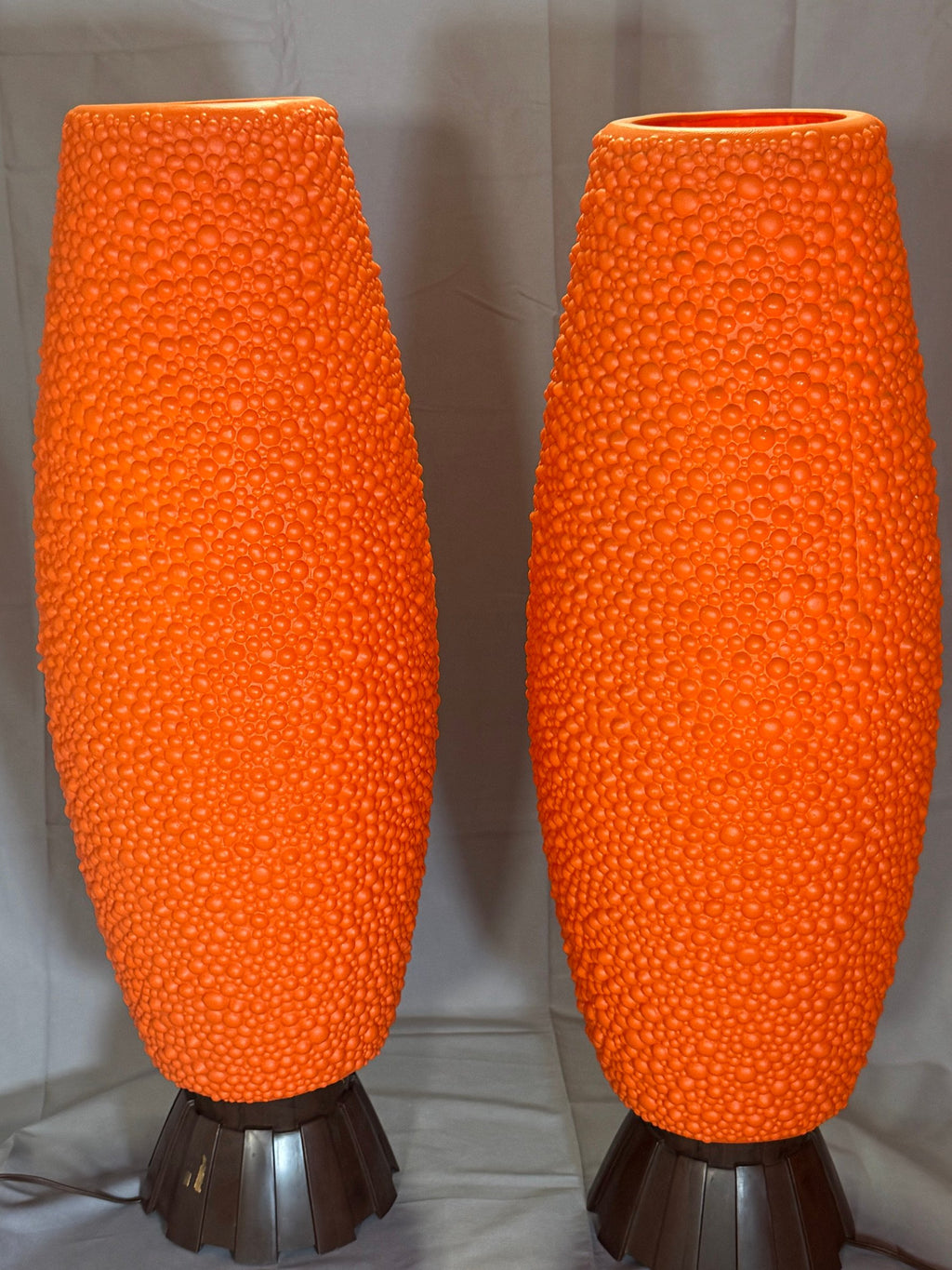 Closer view of the orange textured body and brown base