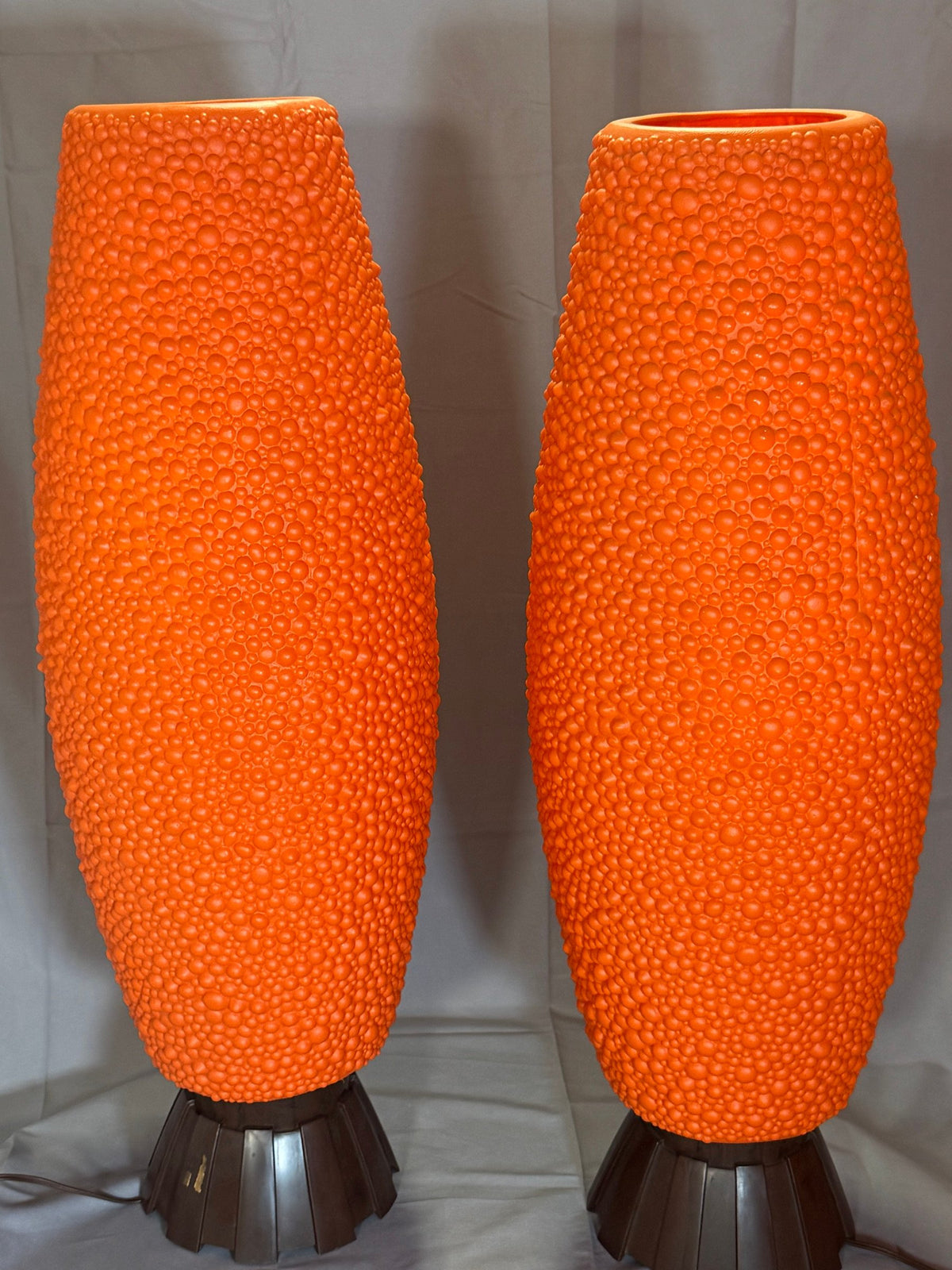 Closer view of the orange textured body and brown base