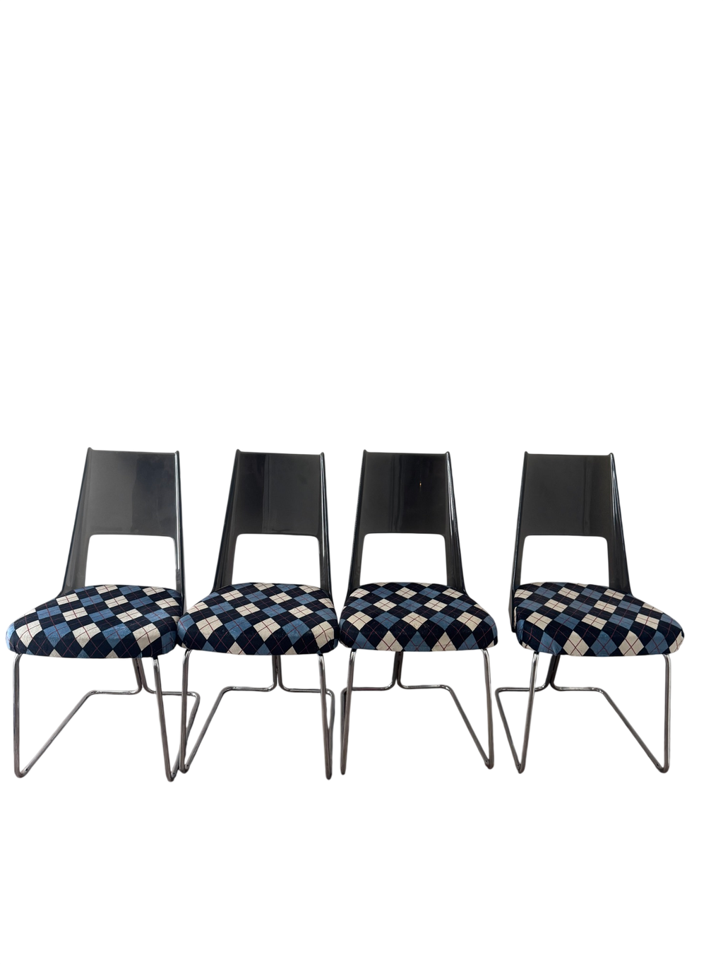 Four matching chairs arranged in a row, displaying consistent design with black backrests, chrome frames, and coordinating argyle upholstery