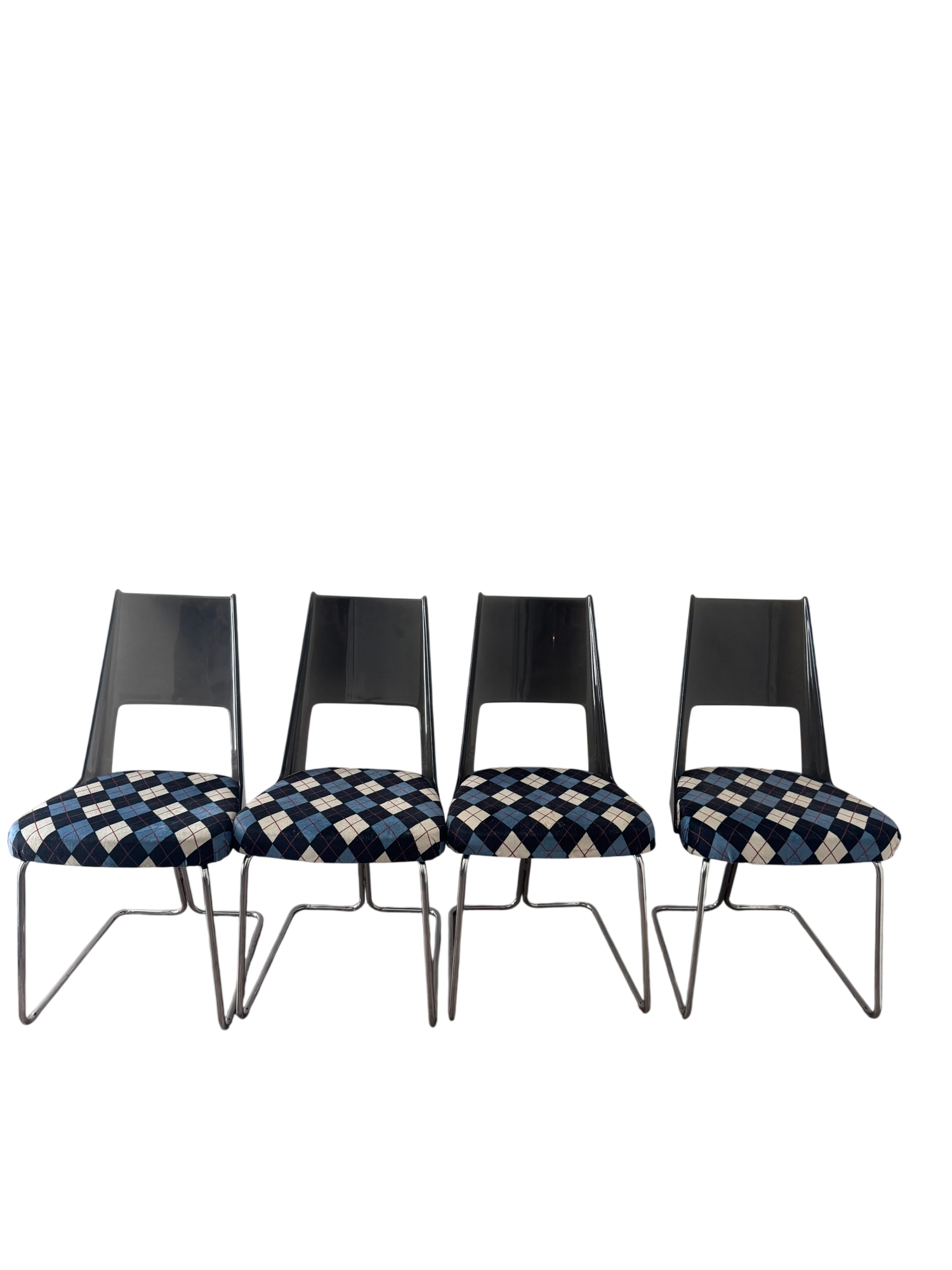 Four matching chairs arranged in a row, displaying consistent design with black backrests, chrome frames, and coordinating argyle upholstery