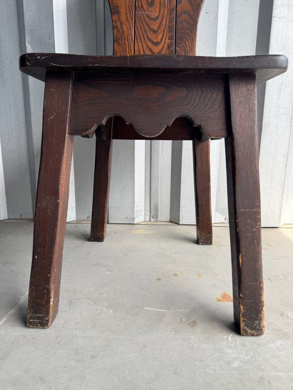 Underside detail showing curved wood bracing beneath seat