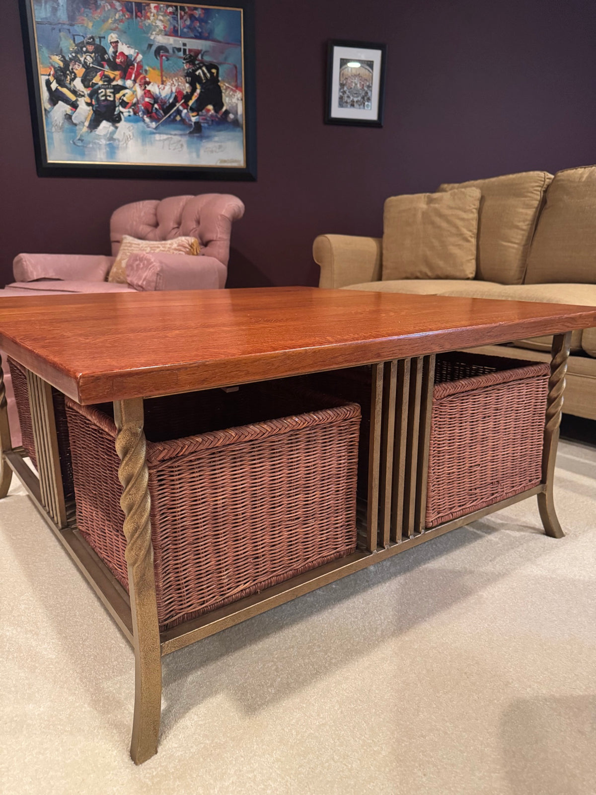 Same coffee table from side angle, showing twisted leg detail, wicker baskets, and oak top grain pattern under showroom lighting