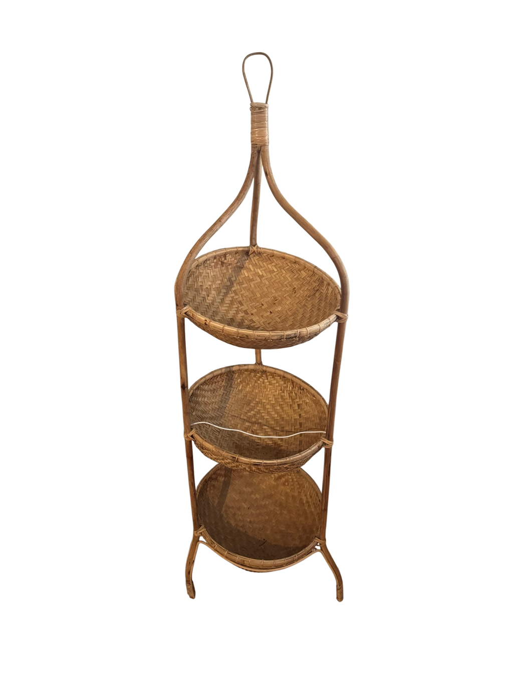 Three-tier rattan basket stand in a corner