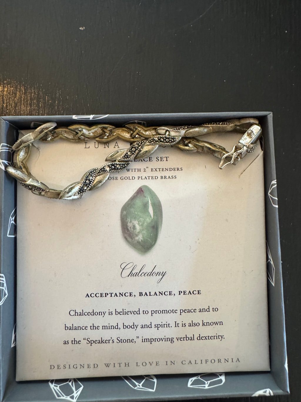 Luna Chalcedony bracelet set in box with rose gold plated brass snake-design chain and informational card describing the stone