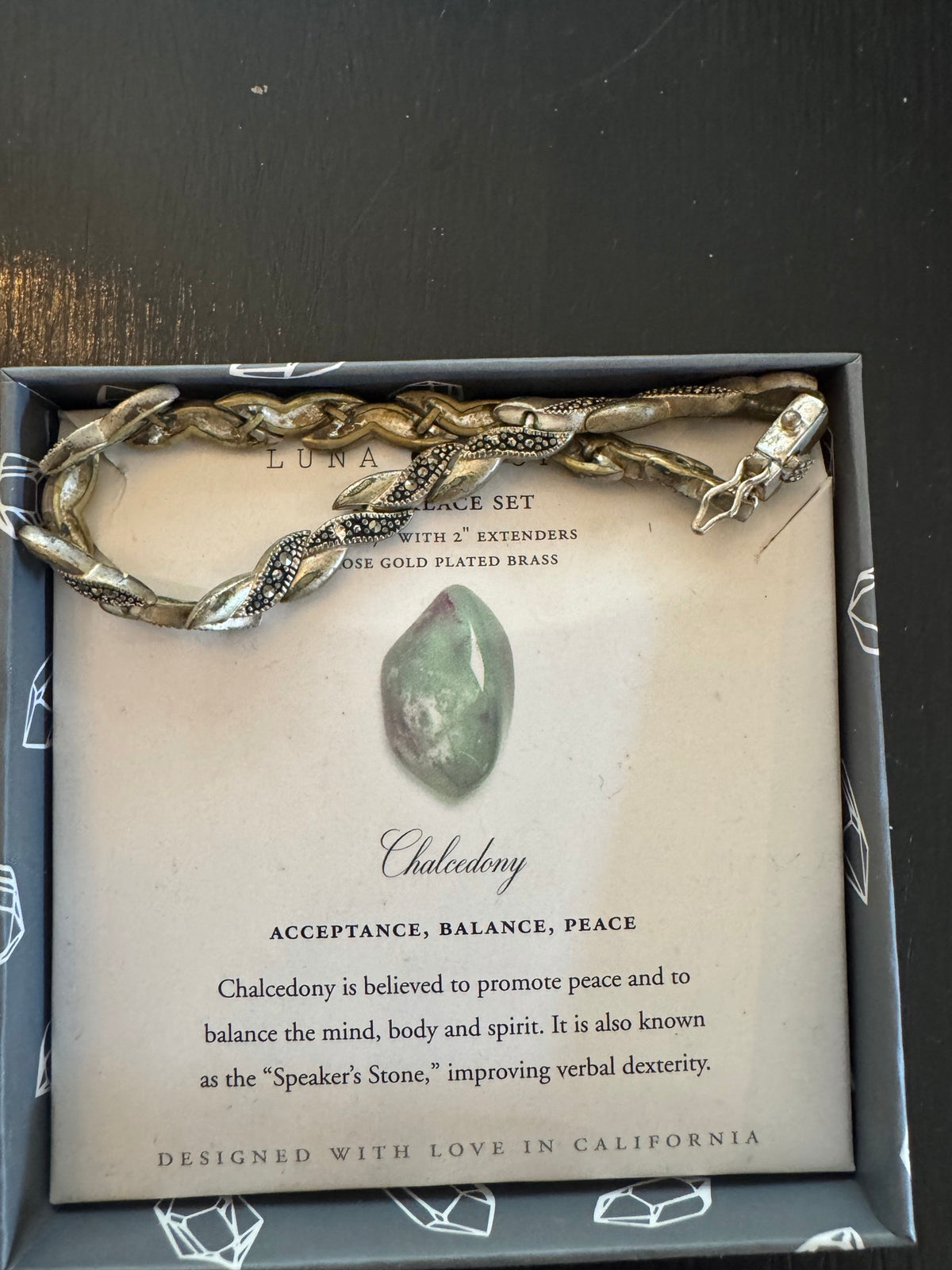 Luna Chalcedony bracelet set in box with rose gold plated brass snake-design chain and informational card describing the stone