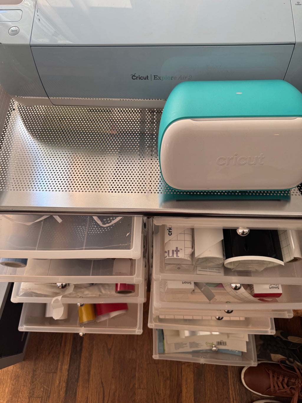 Cricut Joy compact cutting machine with teal top and cream base on work surface