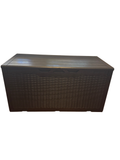 Brown wicker-look deck box against a wall