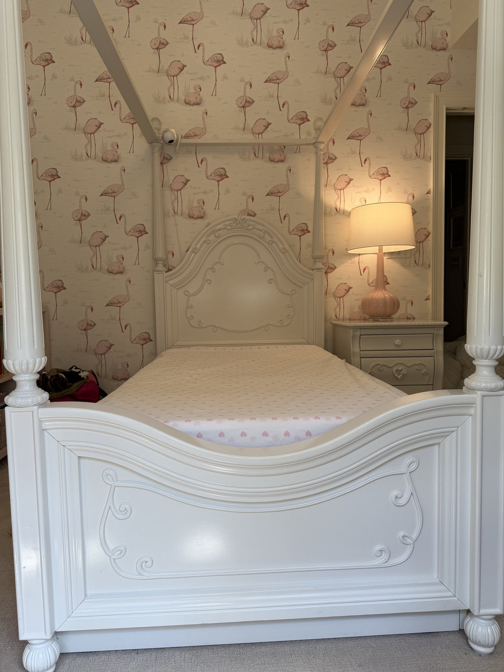 Carved footboard of the Sparkle White canopy bed