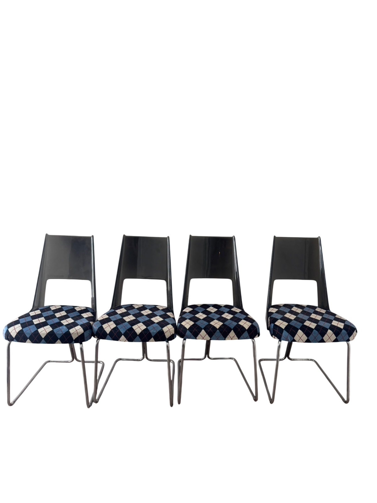 Four cantilever chairs displayed against white wall, metal chrome bases and black curved backs visible