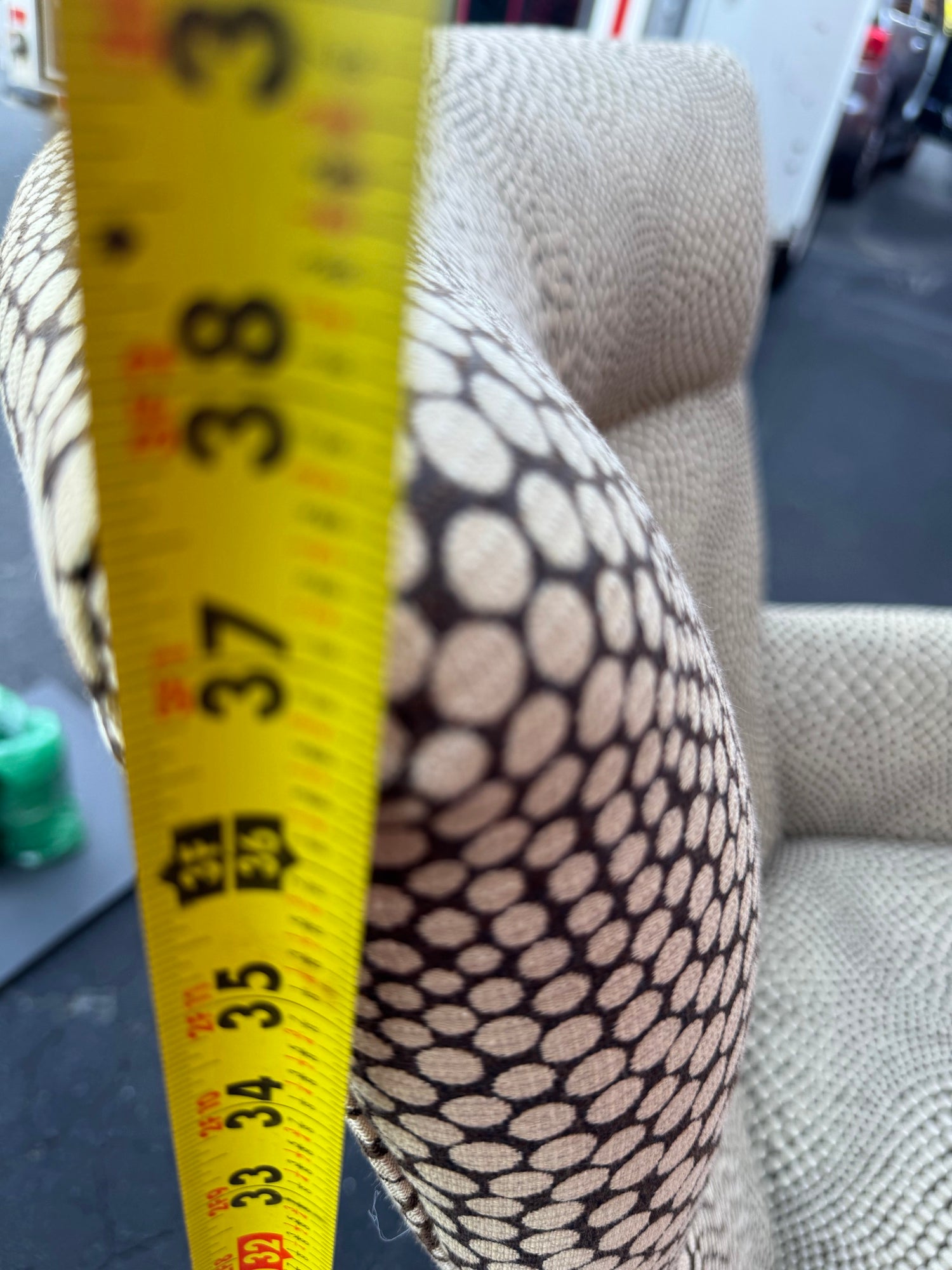Close-up of fabric showing cream circles on dark background with optical distortion pattern