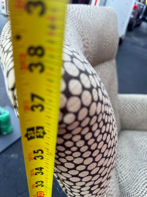 Close-up of fabric showing cream circles on dark background with optical distortion pattern