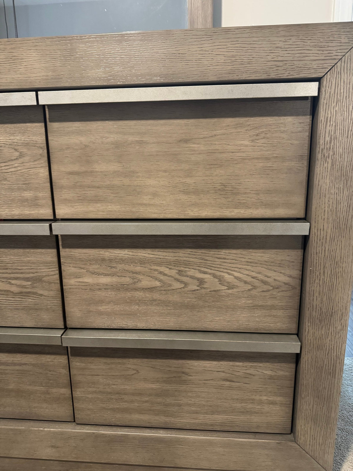Dresser drawer fronts with long brushed metal pulls