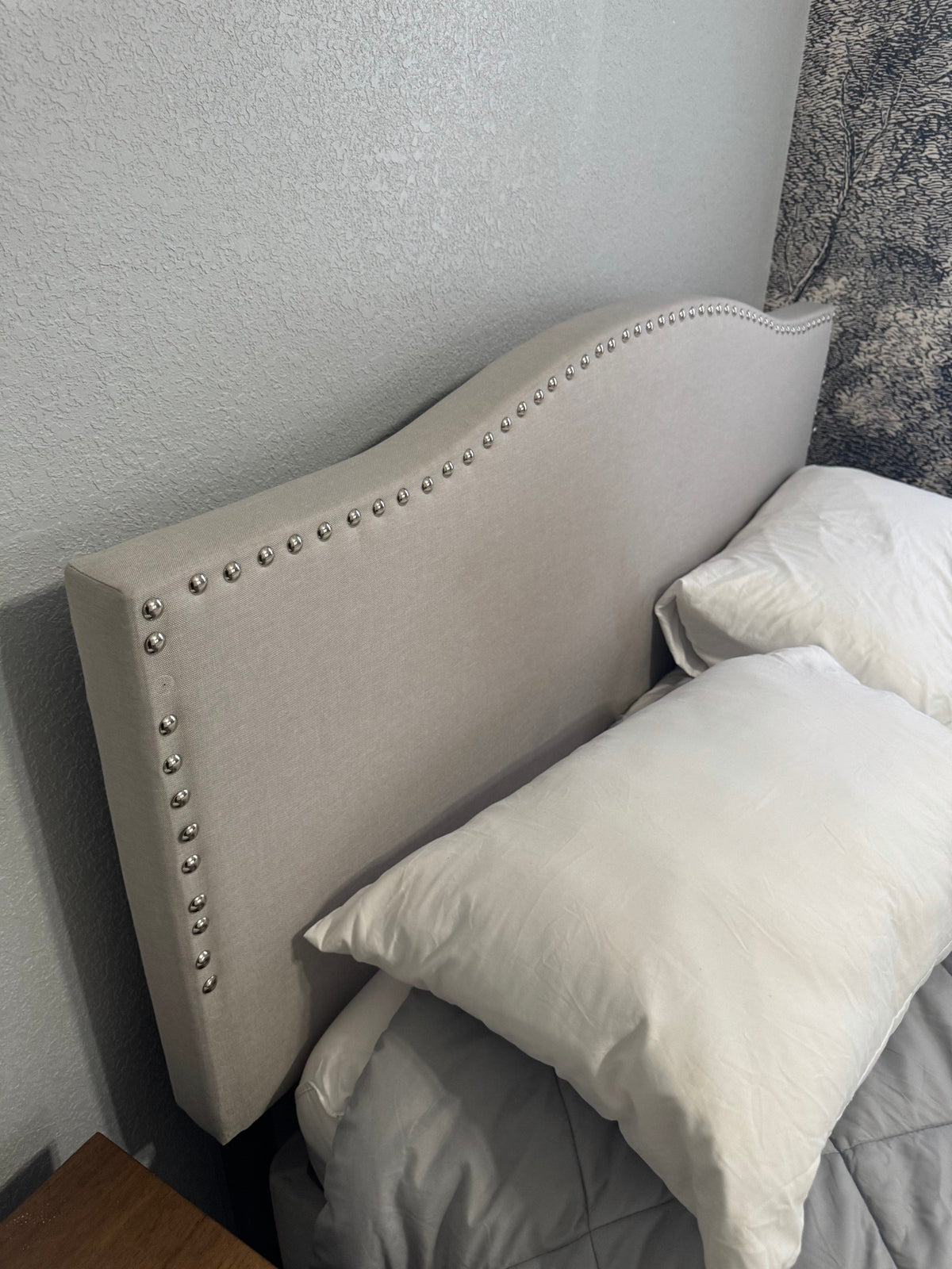 Close view of the nailhead trim on the headboard