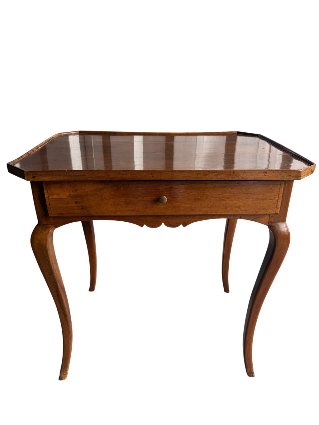 French Provincial walnut side table with serpentine top, single drawer, and curved cabriole legs, front three-quarter view