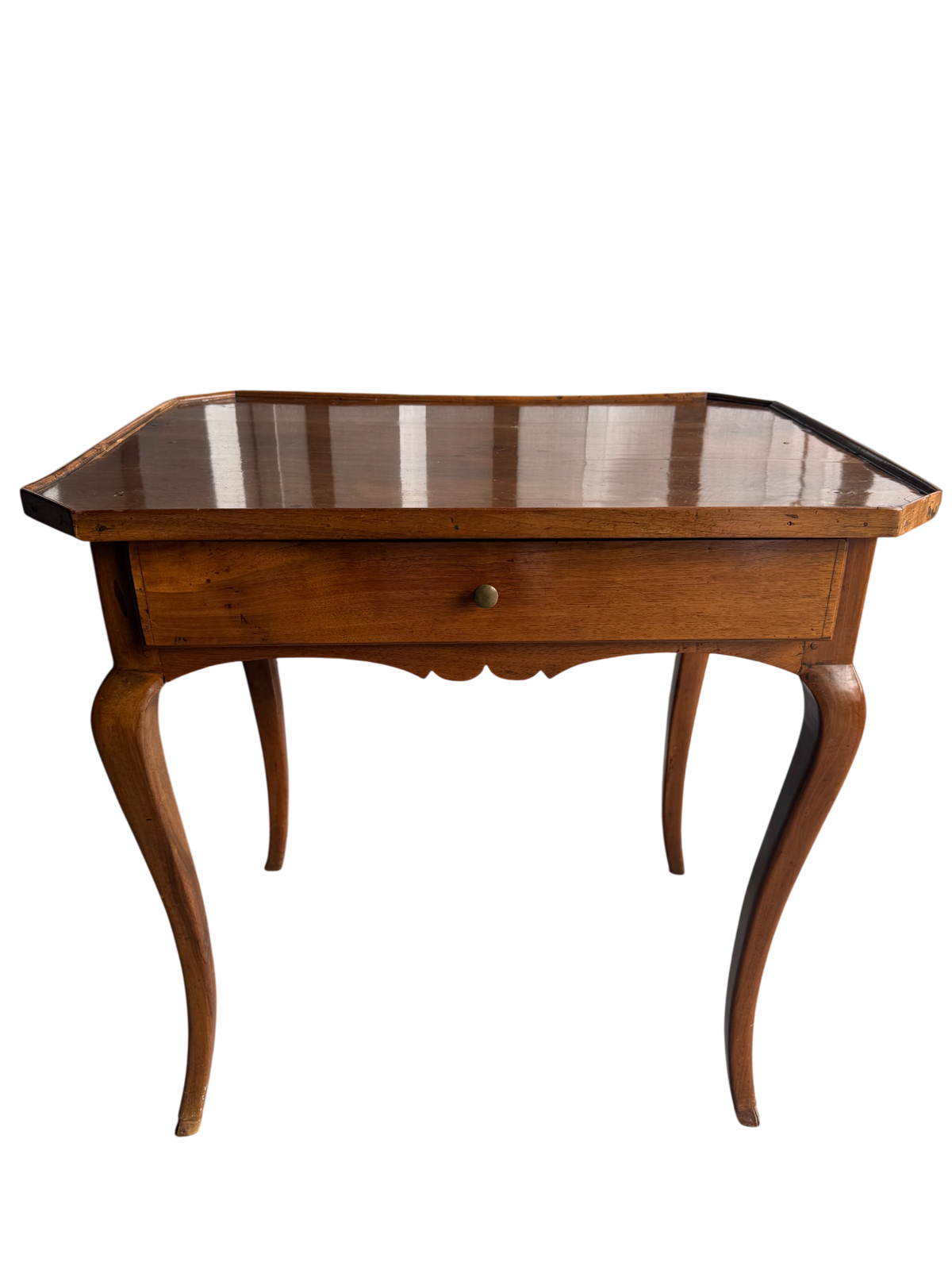 French Provincial walnut side table with serpentine top, single drawer, and curved cabriole legs, front three-quarter view