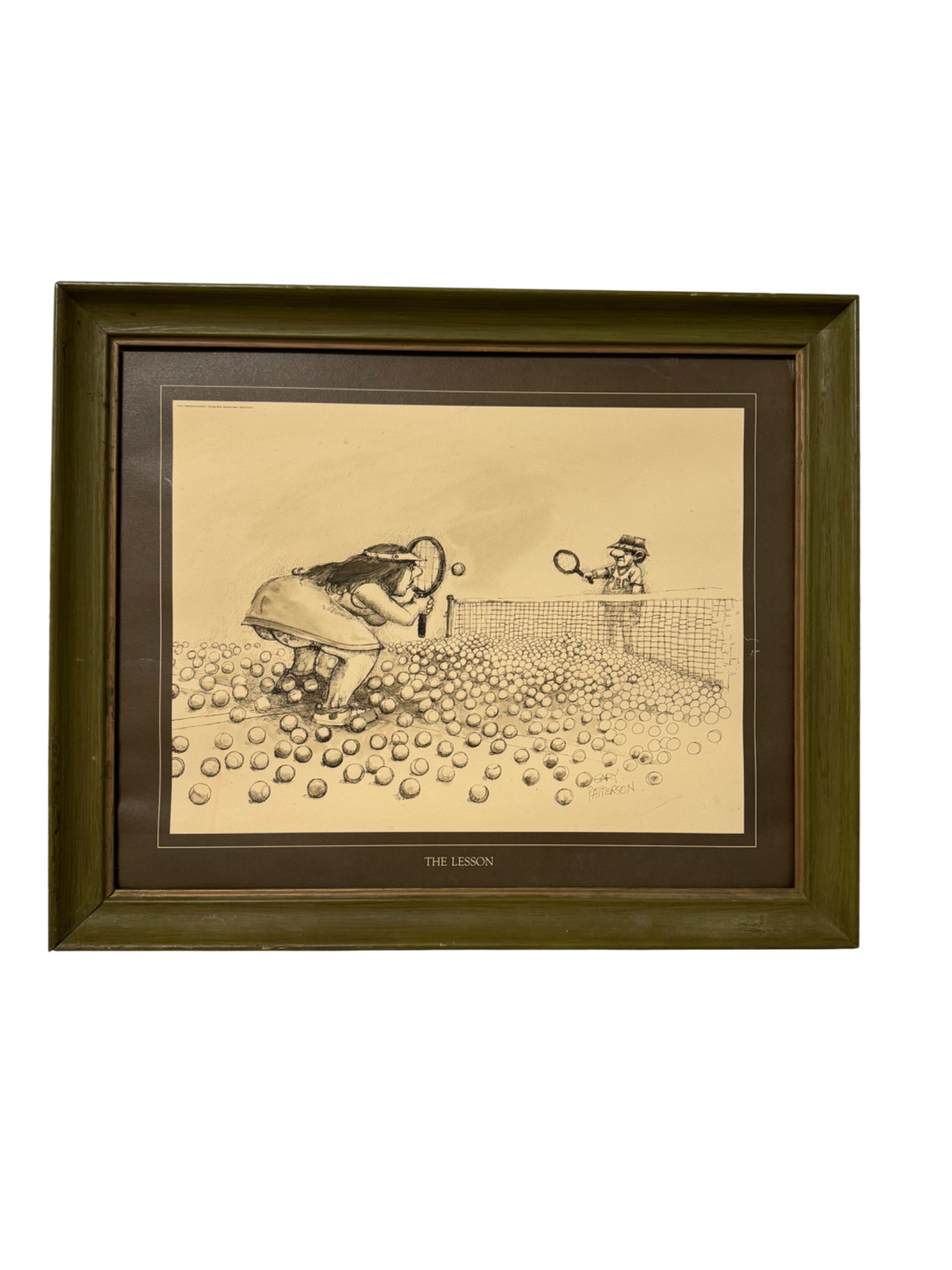 Framed cartoon artwork titled 'The Lesson' showing tennis player bending over with net and opponent, olive green wooden frame with matting