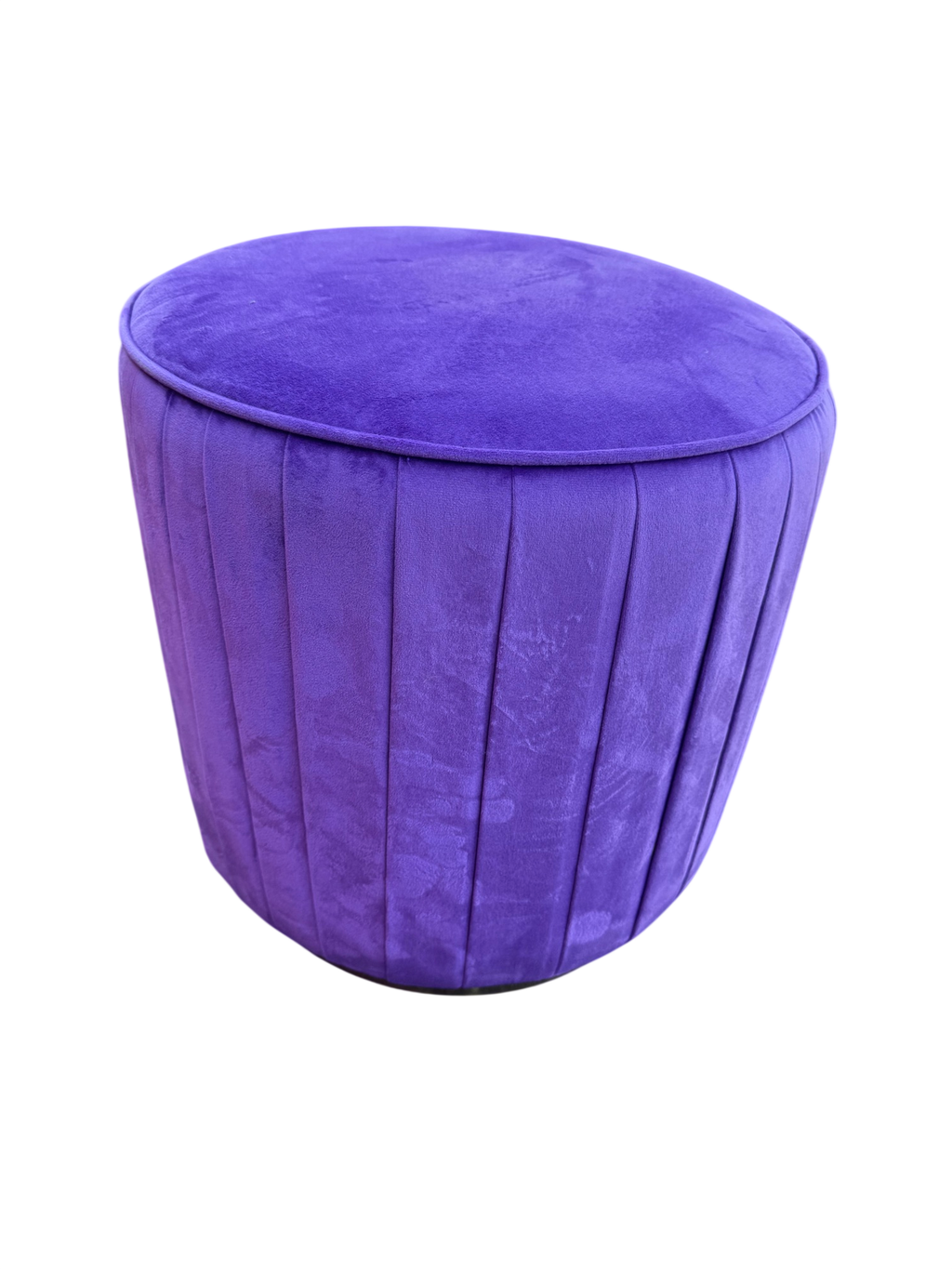 Purple velvet channel-tufted round ottoman pouf, angled view showing tufted sides and rounded top